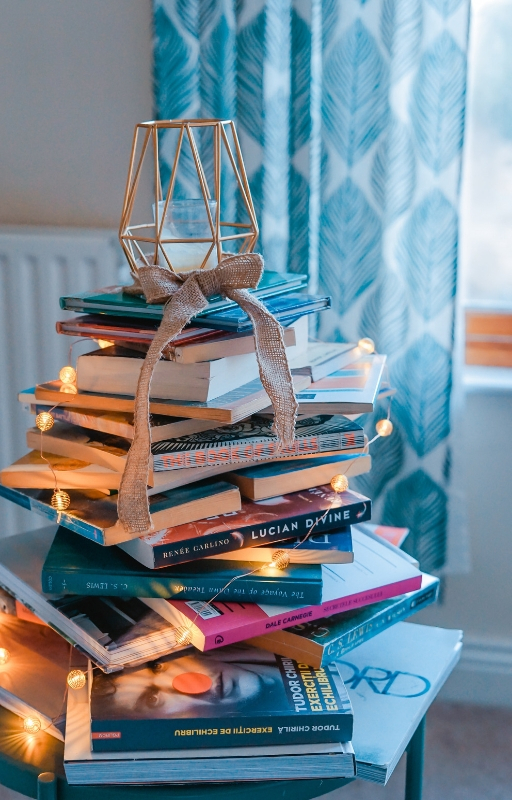 brown wooden framed candle holder on top of books