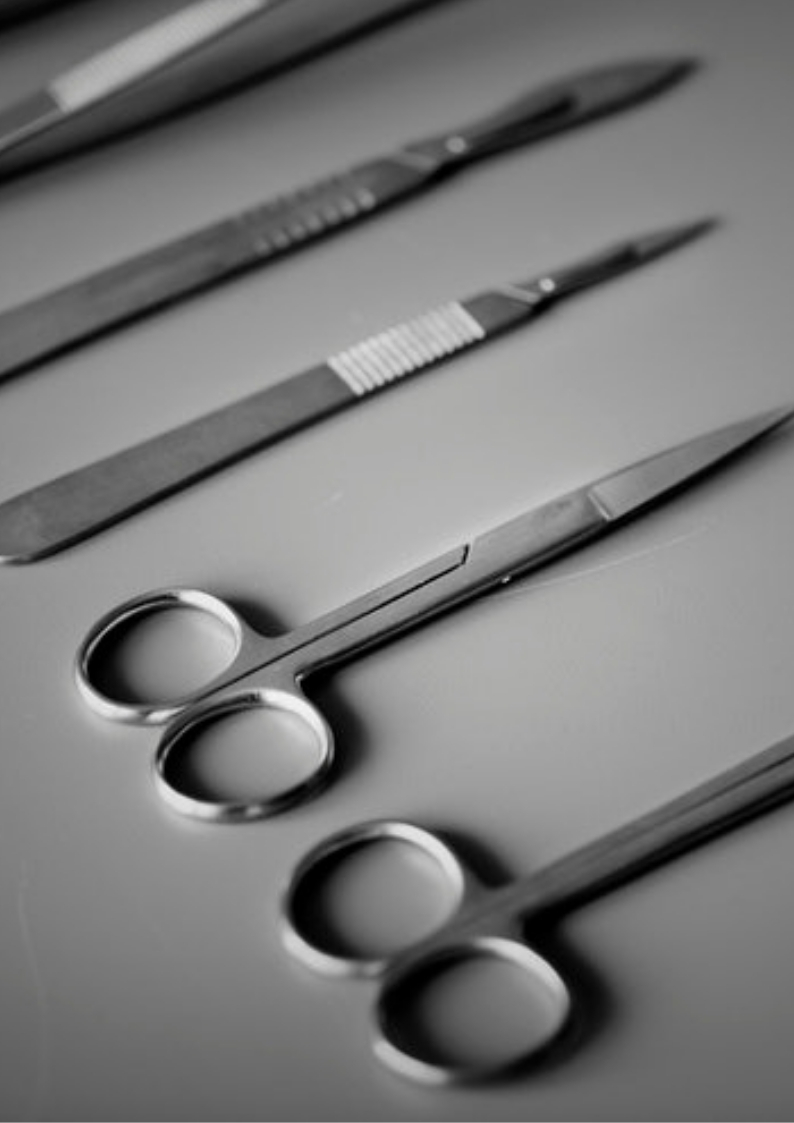 medical scissors and scales on a grey background 