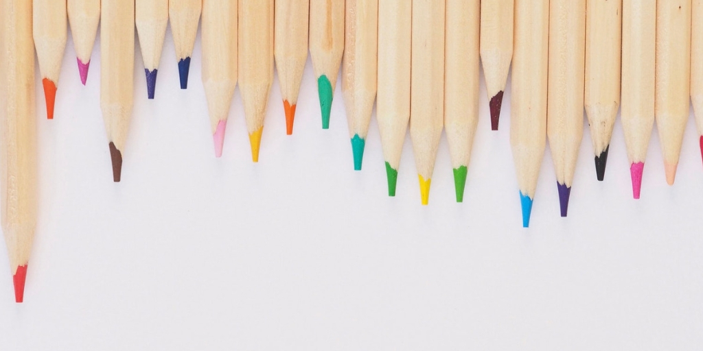 Image of coloured pencils place at the top of the white background 