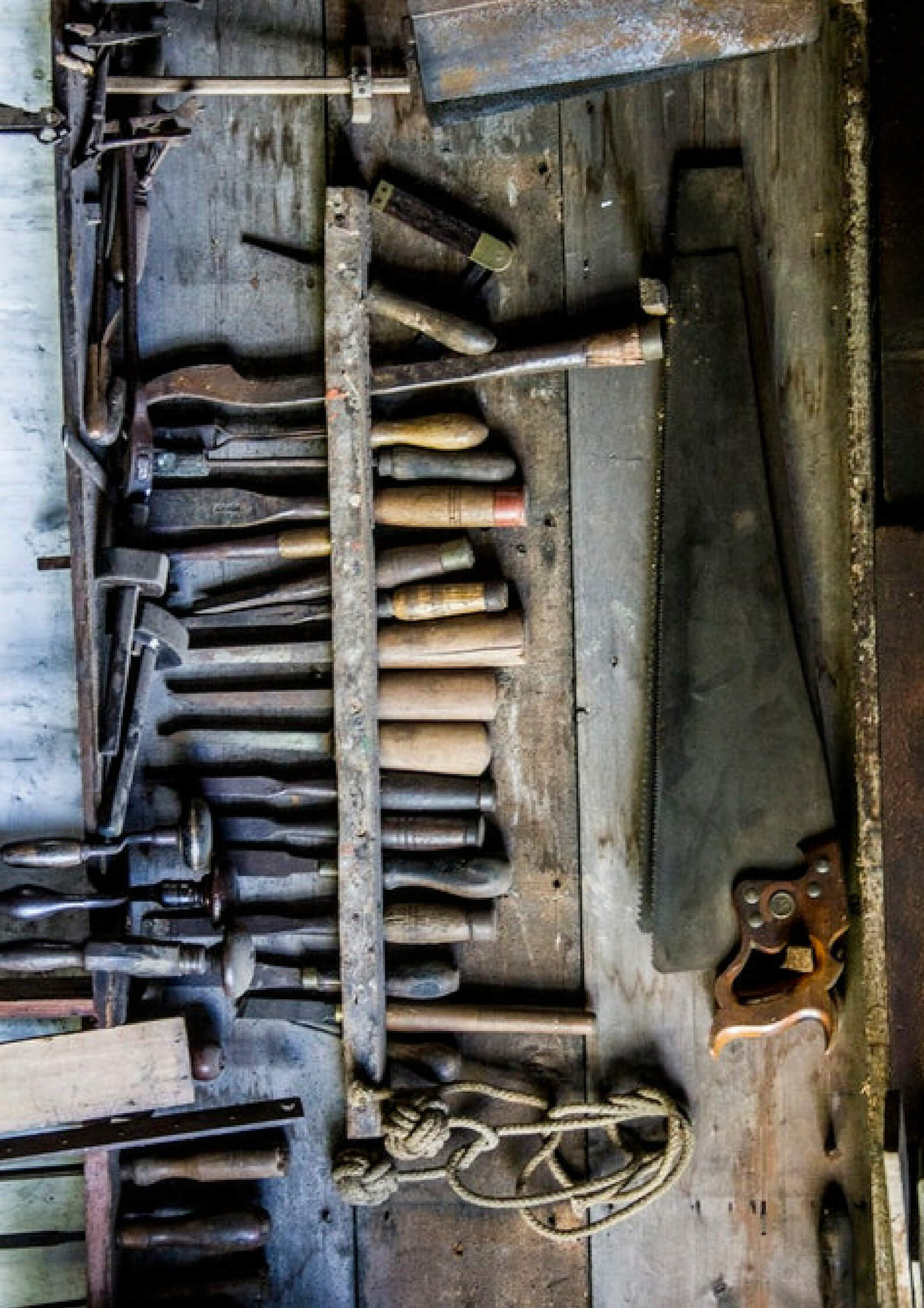 Image of building tools placed on a wooden background 