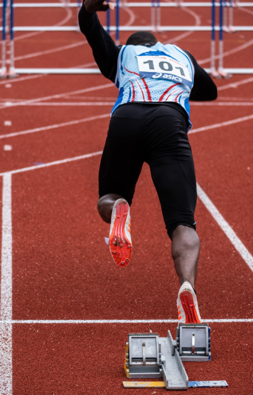 An athlete on the starting position of a race event during daytime