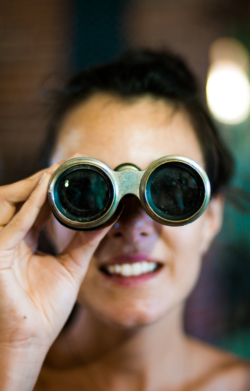 a woman holding a binocular against her eyes