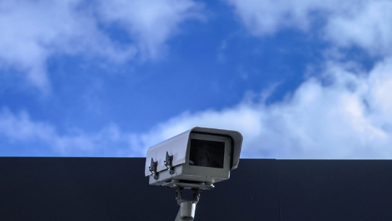 security camera outside a building and the sky visible above it