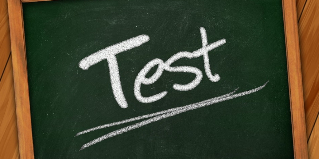 Image of green board where test is written with chalk