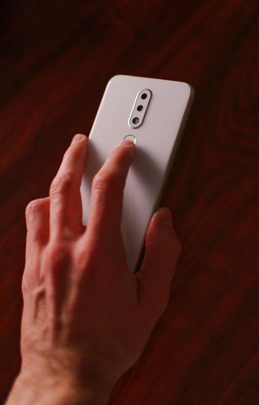 A man unlocking phone with finger touch