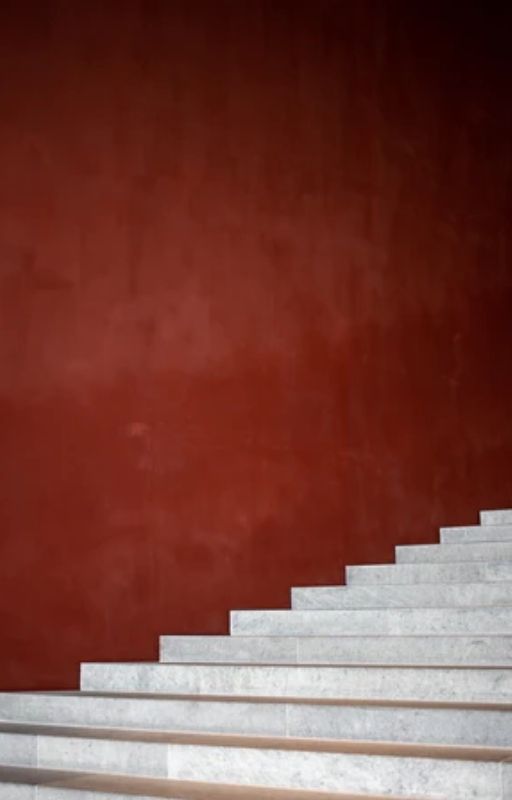 Gray concrete stairway on a red background
