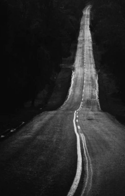 Black and white image of an empty road