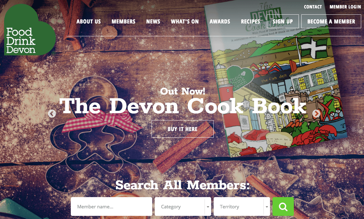 Homepage of Food Drink Devon with the image of a book kept on a wooden surface