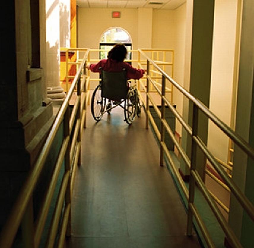 A hospital ramp with a woman is sitting in a wheelchair
