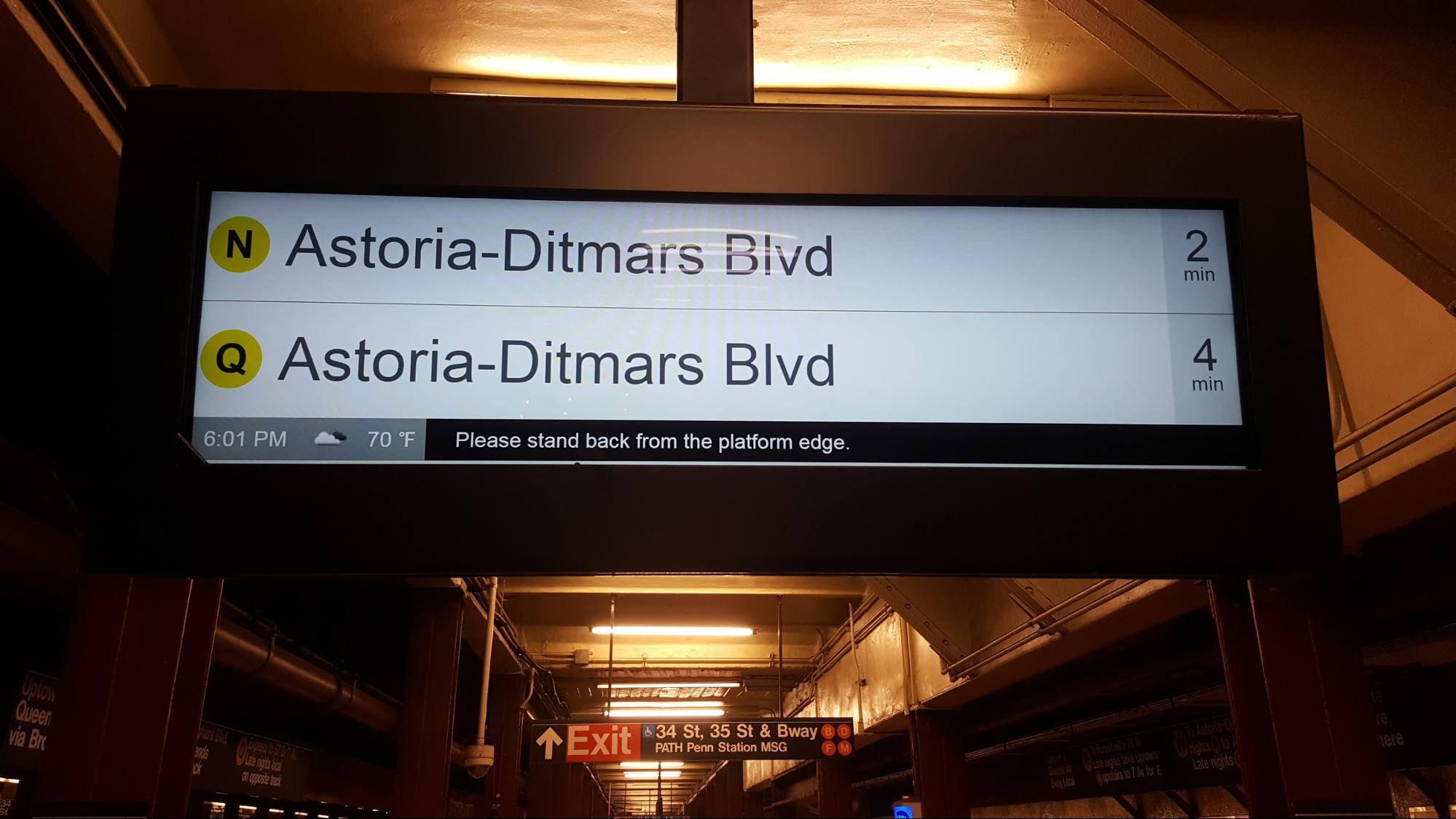 A digital signage screen in New York railway station reading station name and time of arrival