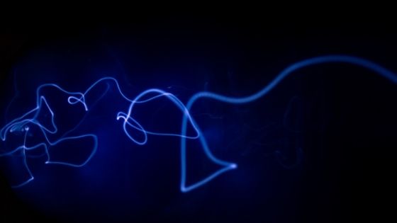 a blue beam of light against black background