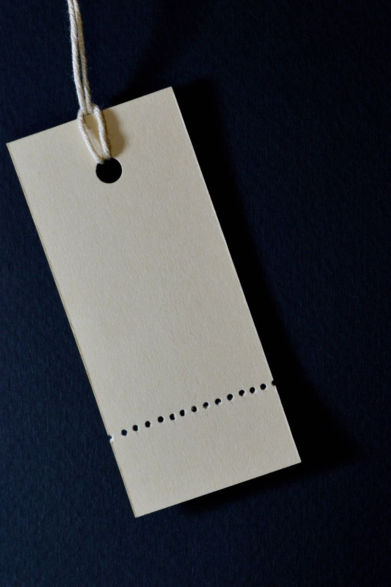 A blank tag is seen hanging off of a thread.