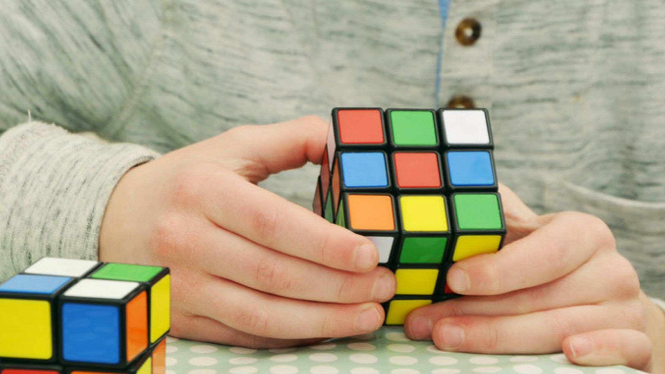A man is solving the rubik's cube.