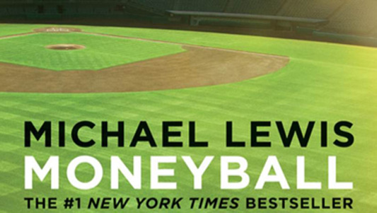 Top view of a baseball stadium and 'Michael Lewis', 'Moneyball' and 'The #1 New York Times Bestseller' written over bottom region