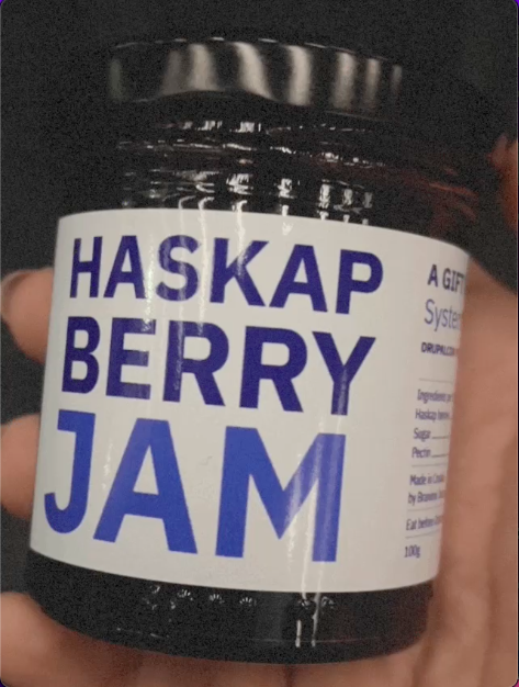 bottle with white sticker and text Haskap berry jam