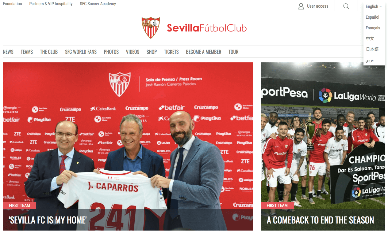 Homepage of Sevilla FC website with three people holding the team jersey on left and the football team posing for the camera on right 
