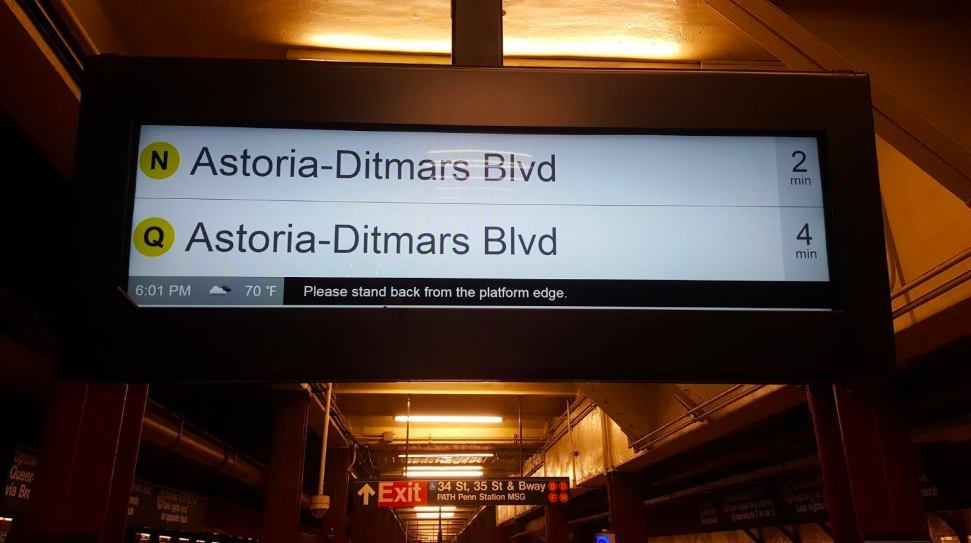 A digital signage powered board at a railway station with the name of railway station written inside it