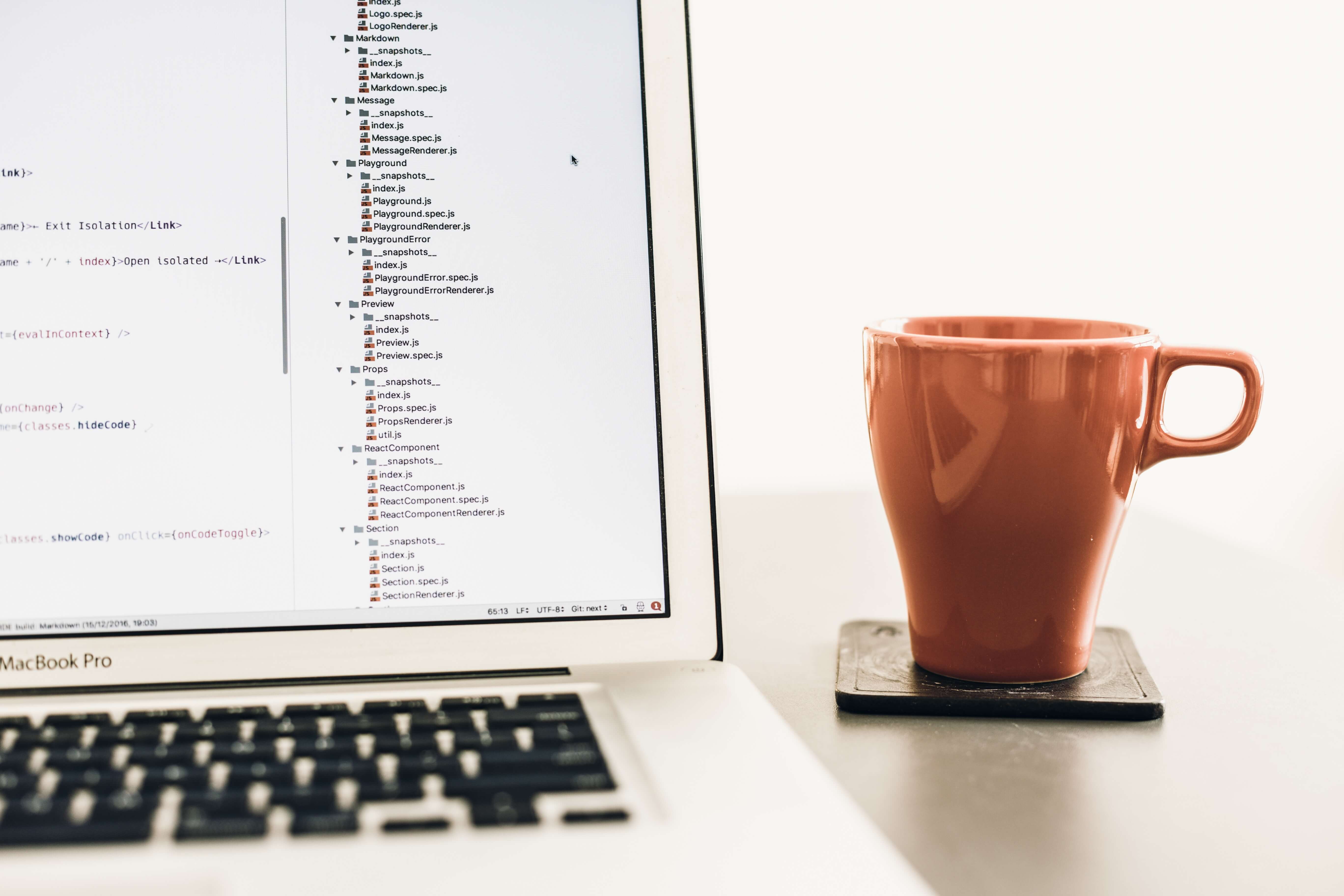 a cup of coffee with a laptop on the table