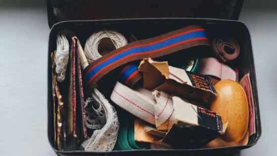 image showing a vintage suitcase with some random things inside it