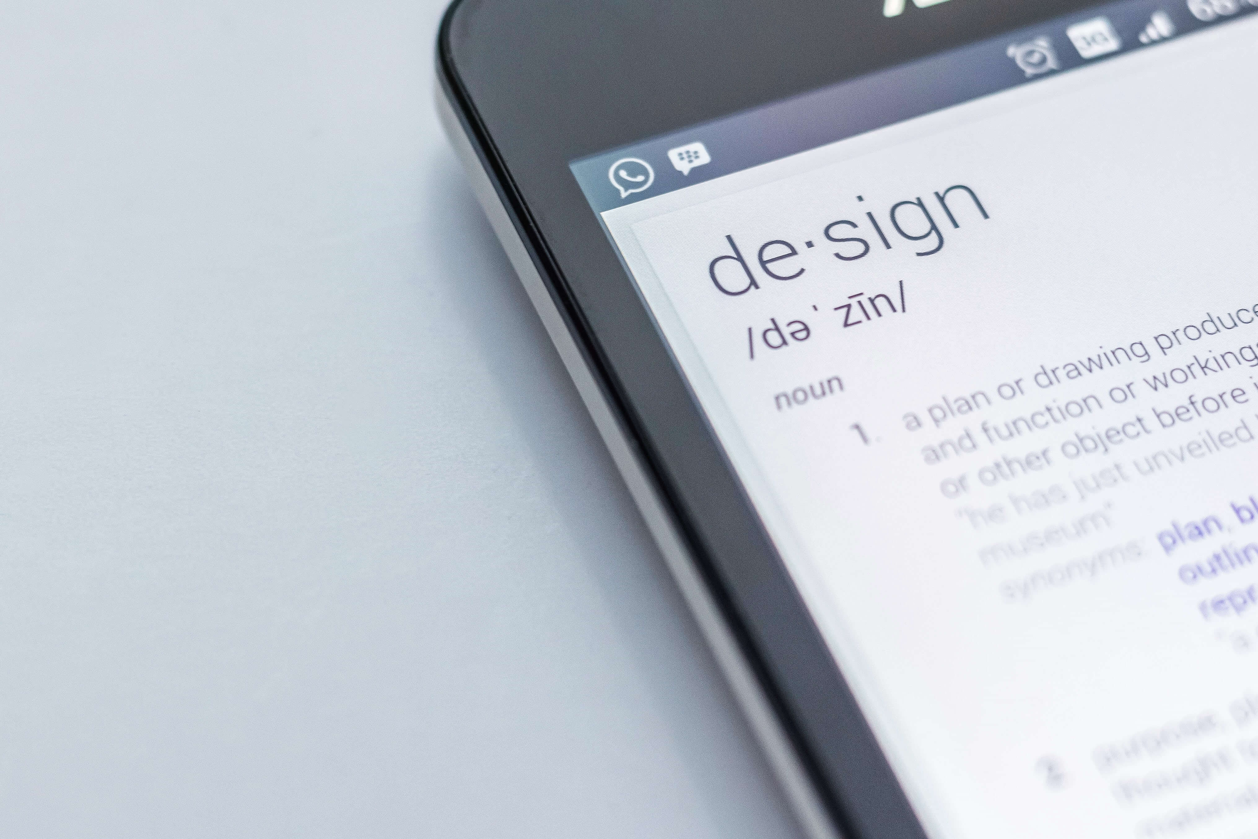 a smartphone displaying the word design and its meaning in text