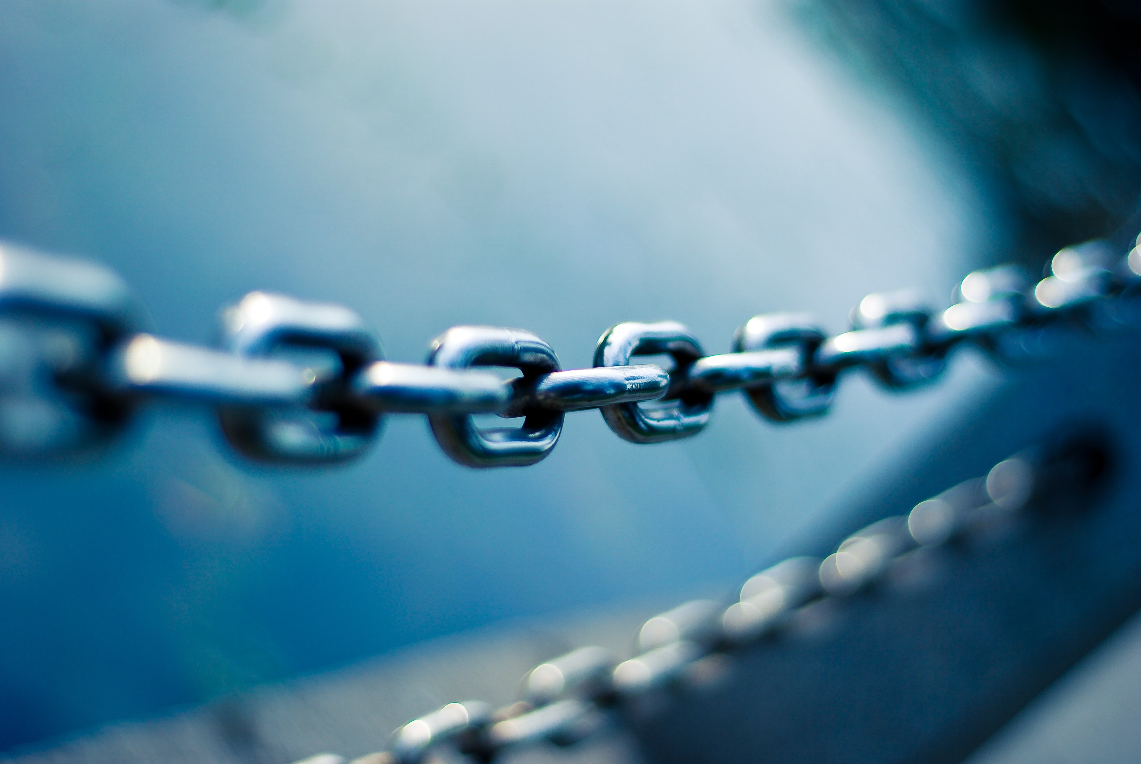 A stainless steel chain amidst blue backdrop representing SEO and backlinks