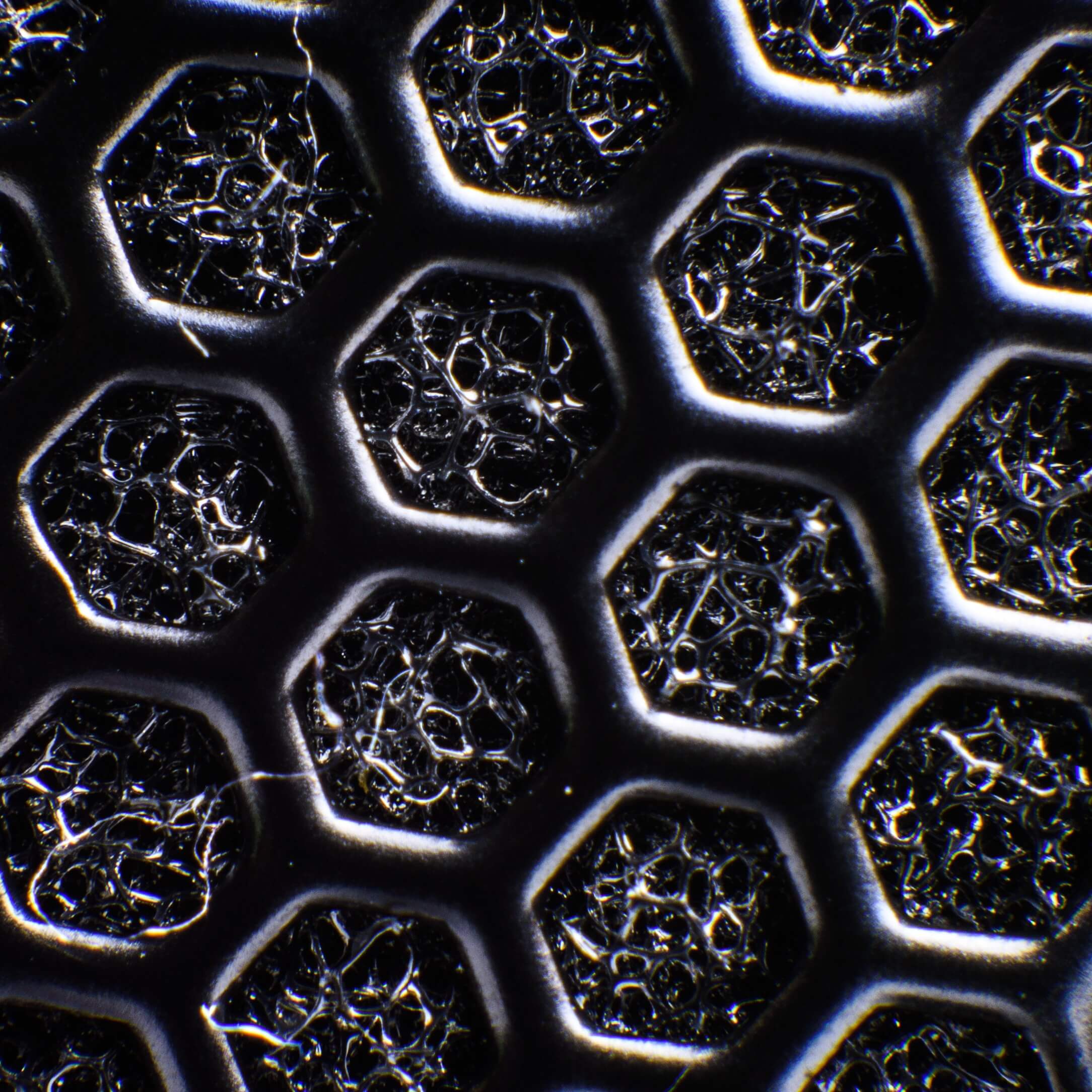 macro photography of grey honeycomb surface