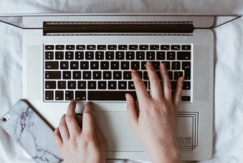 hands working on a laptop