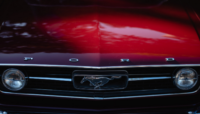 close up photography of front view of red Ford car