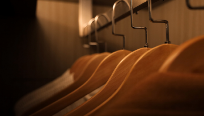 Cloth hangers lined up in a dimly lit room
