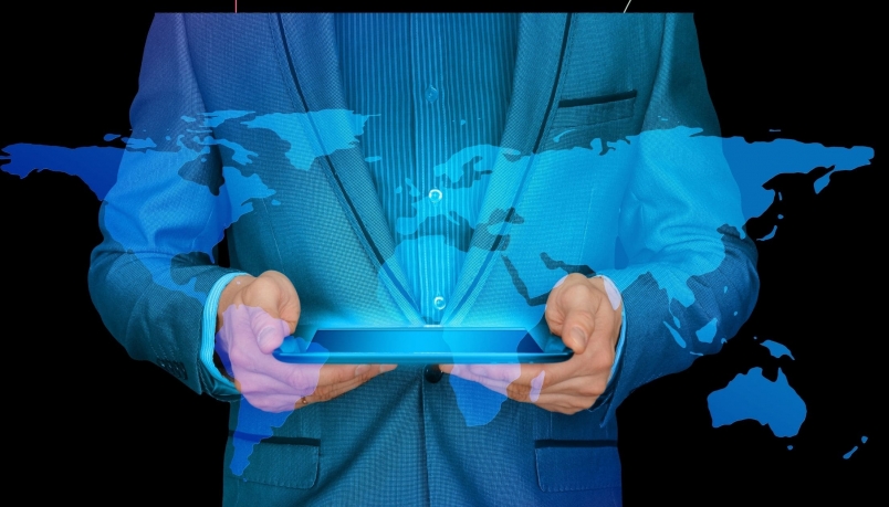 two hands holding a phone and a blue hologram of the world map emerging from it