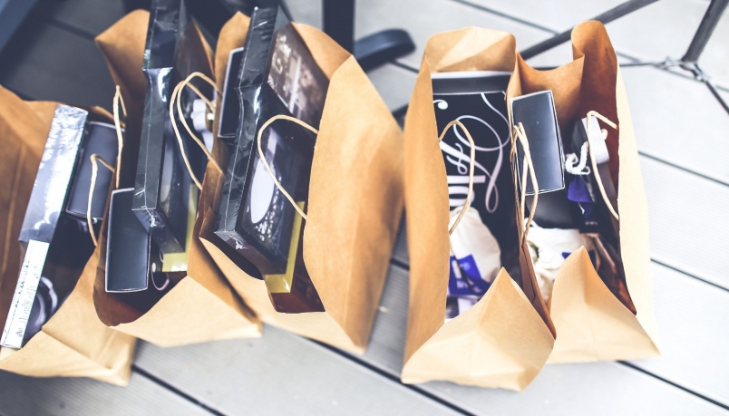 Five shopping bags are kept on the floor.