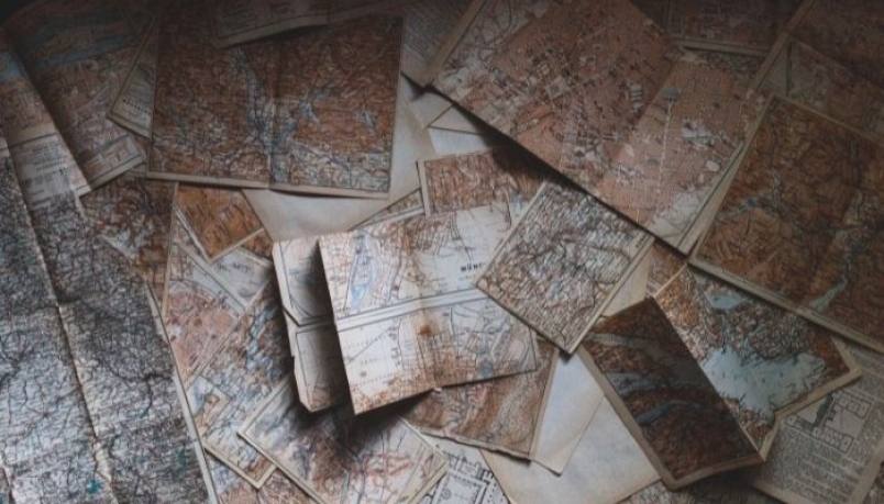 old dusty maps lying on the ground