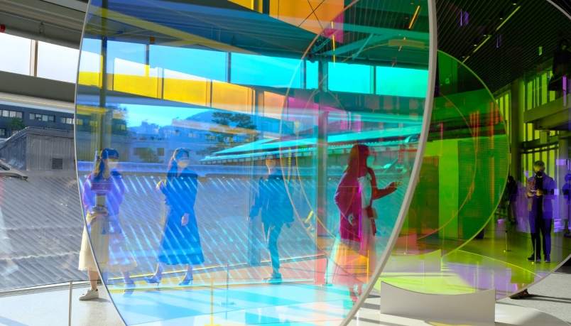 An image displaying people inside a building filled with big glasses
