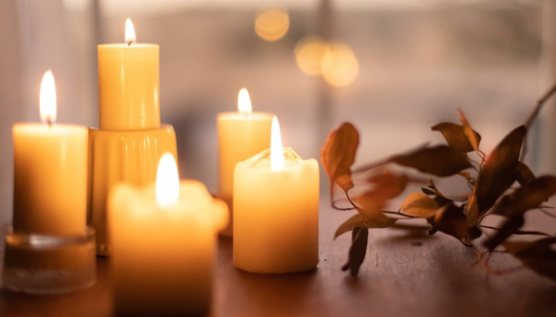 An image filled with candles and flowers