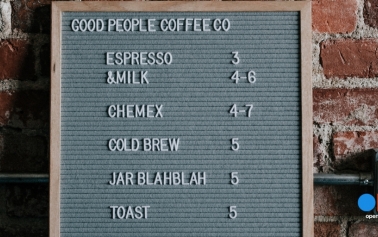 a green menu board with a list of beverage