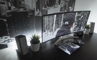 a black and white photo of a desktop kept near a window