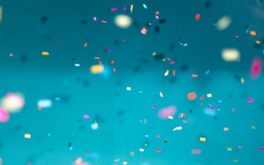 confetti all over against light blue background 