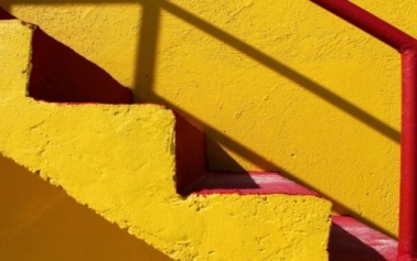 a yellow stairs and its shadow