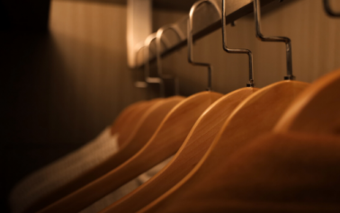 Cloth hangers lined up in a dimly lit room