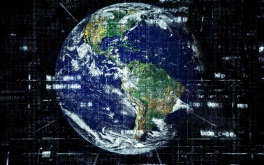The picture shows the Earth with many signs and numbers revolving around it showcasing the advent of technology.