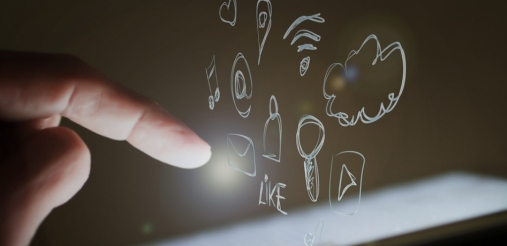Image of a mobile phone where a hand is touching the screen and many social bubble are emerging out of it