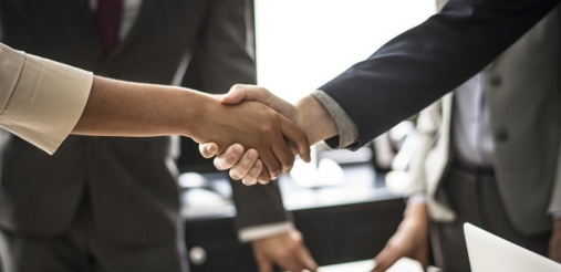 Image of two hands shaking each other in a meeting