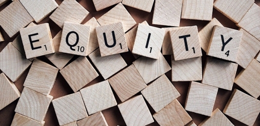 Image of word blocks that is placed in the middle of the picture which says equity