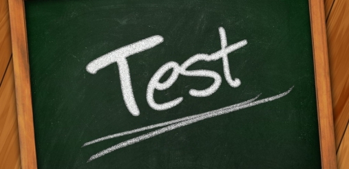 Image of green board where test is written with chalk