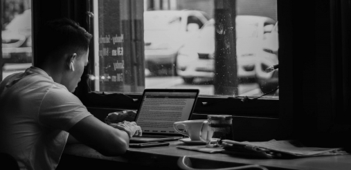 Guy working on laptop in a coffee shop