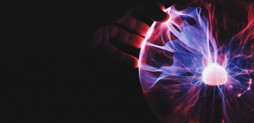 Human hand holding plasma ball