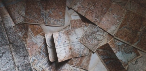 old dusty maps lying on the ground