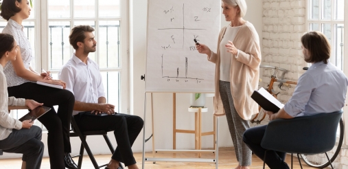 A mentor can be seen teaching a some students.