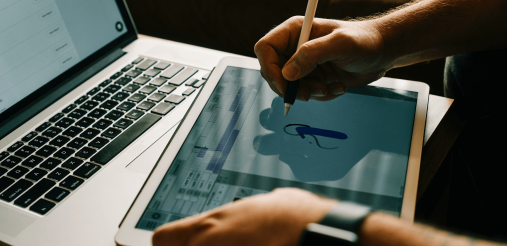 An image displaying a person working on a laptop
